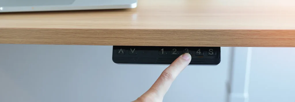 Standing desk operation panel with finger pressing to change the settings.
