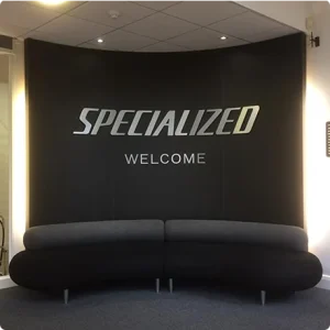 Reception room with black walls and curved sofa.