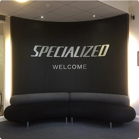 Reception room with black walls and curved sofa.