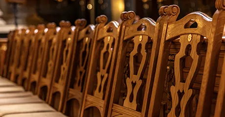 Row of decorative, numbered wooden chairs.
